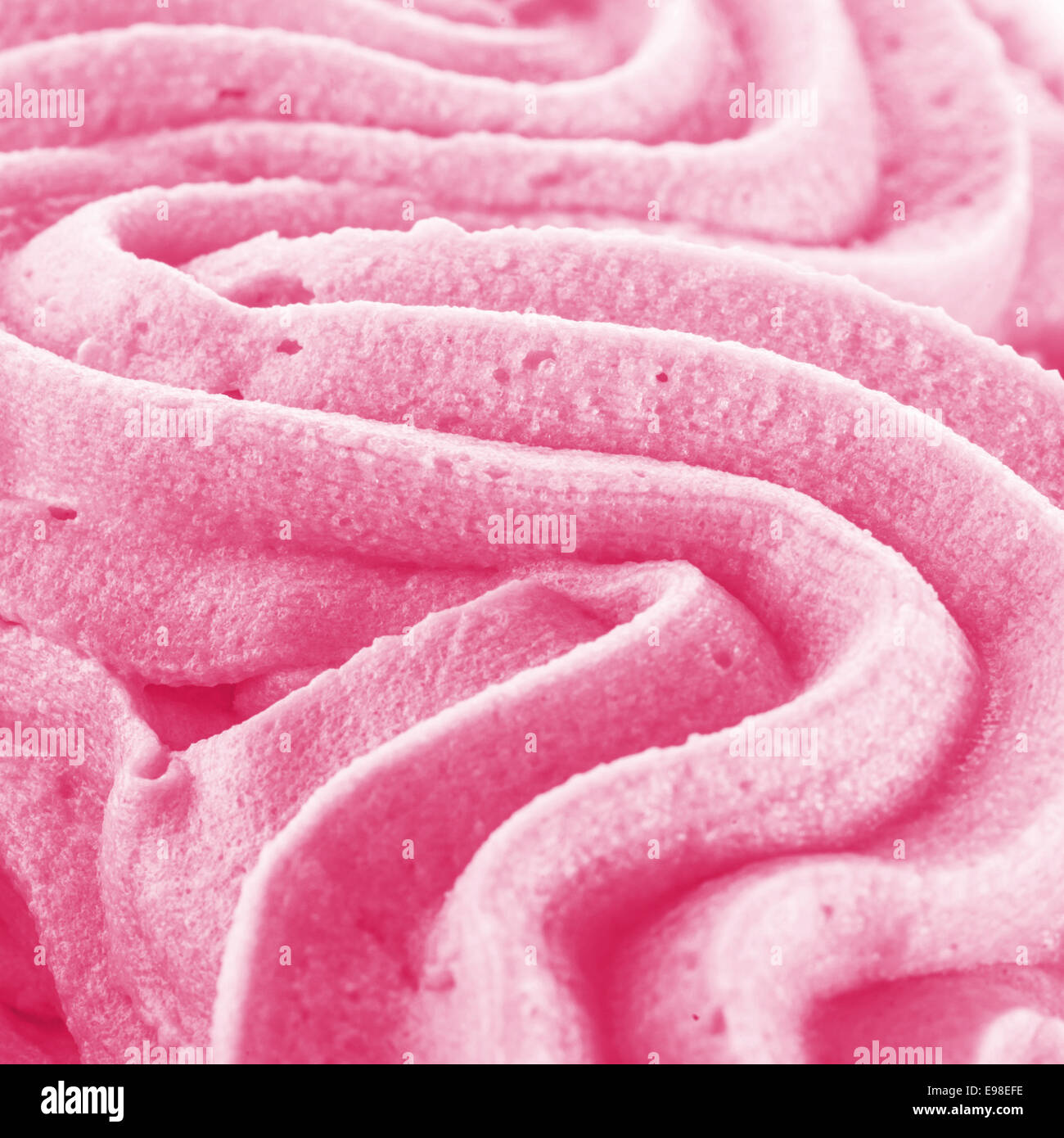 Background texture of swirling pink Italian ice cream with a ridged pattern in square format Stock Photo