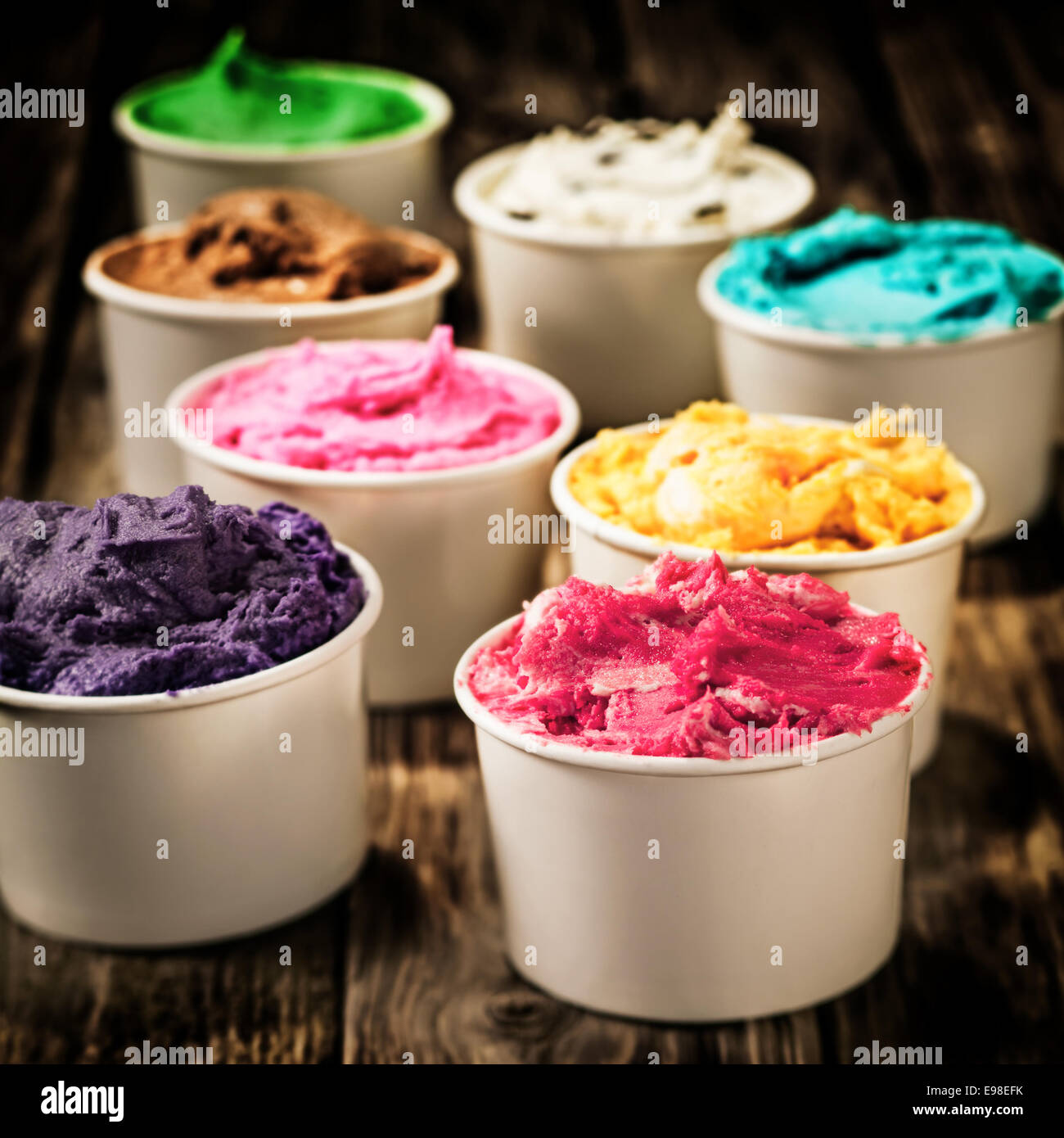 Assorted colorful tubs of fresh dairy ice cream in multiple colors and flavours for a refreshing cold treat on a hot summer day Stock Photo