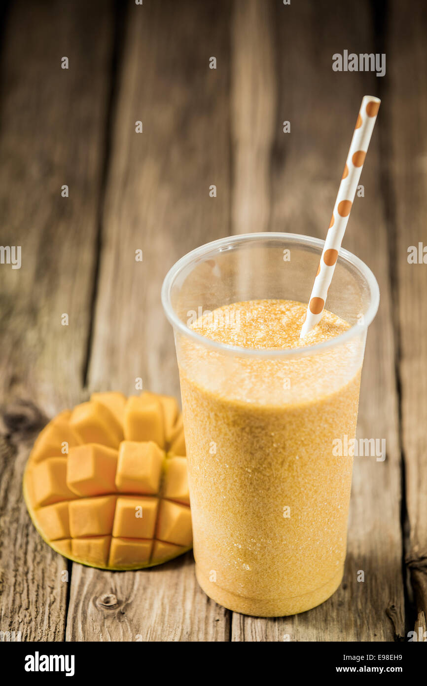 High Angle View Of A Glass Of Tropical Mango Smoothie Blended With Yogurt And Ice Cream With Fresh Fruit On An Old Weathered Wooden Table With Copyspace Stock Photo Alamy