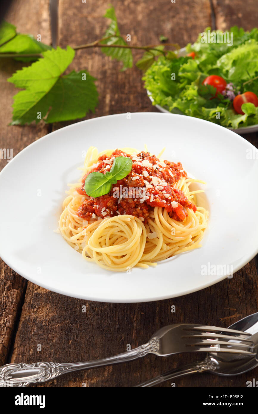 Plate Of Healthy Italian Spaghetti With Bolognaise Sauce Served With A Fresh Green Salad Stock Photo Alamy