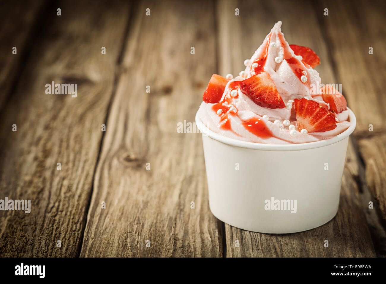 Ripe red tropical strawberries and vanilla ice frozen joghurt cream for