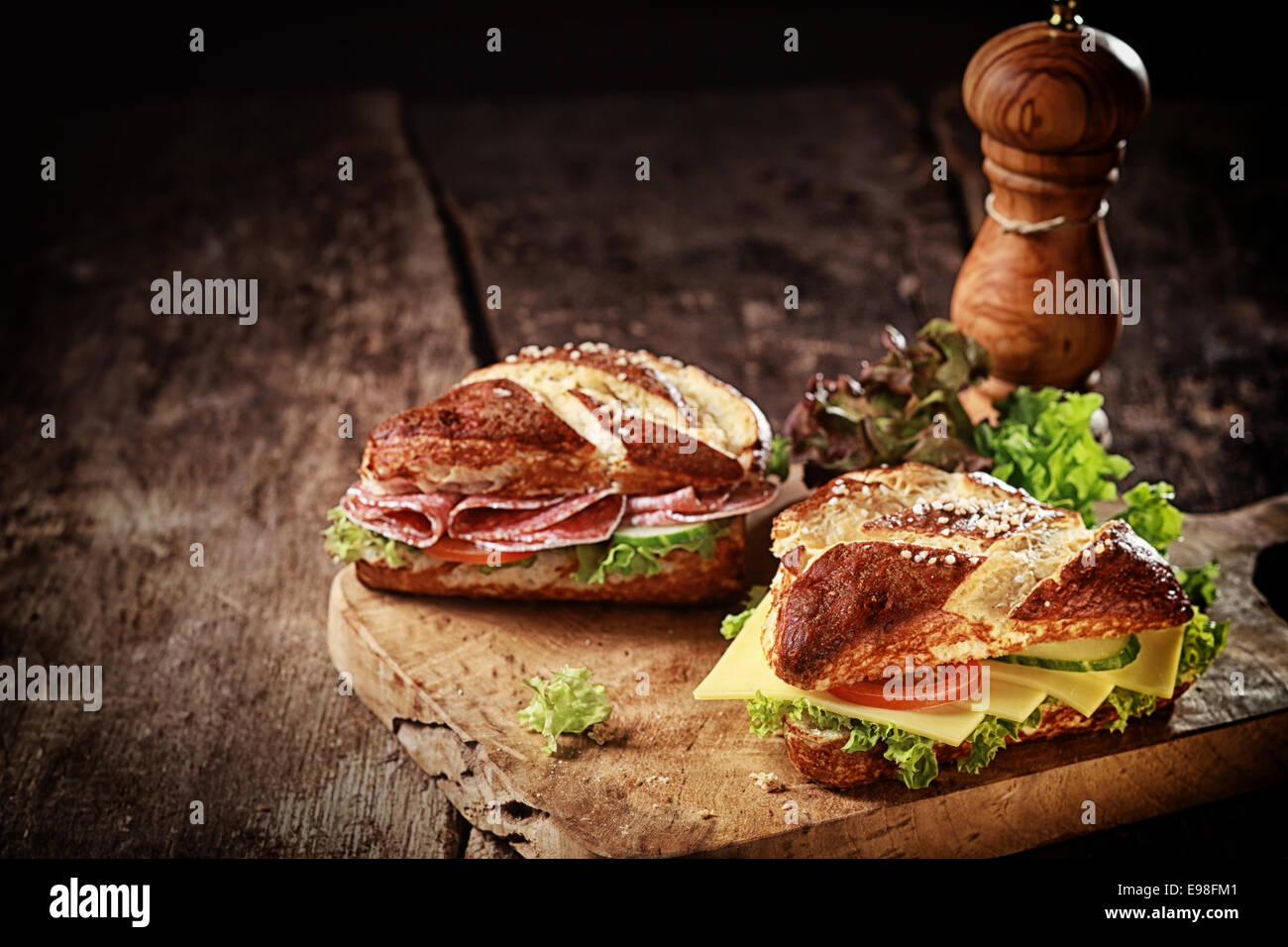 Crusty brown lye bread roll sandwiches with a cheese, salami, lettuce