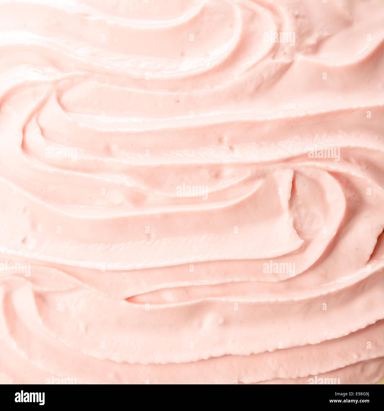 Tasty cold pink berry frozen yoghurt or ice cream background with a smooth creamy texture for a delicious refreshing summer dessert Stock Photo