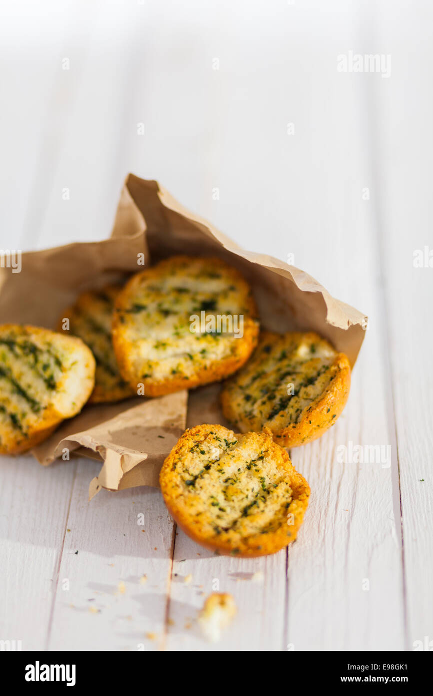 Golden crunchy grilled herb bread from the BBQ spilling from a torn