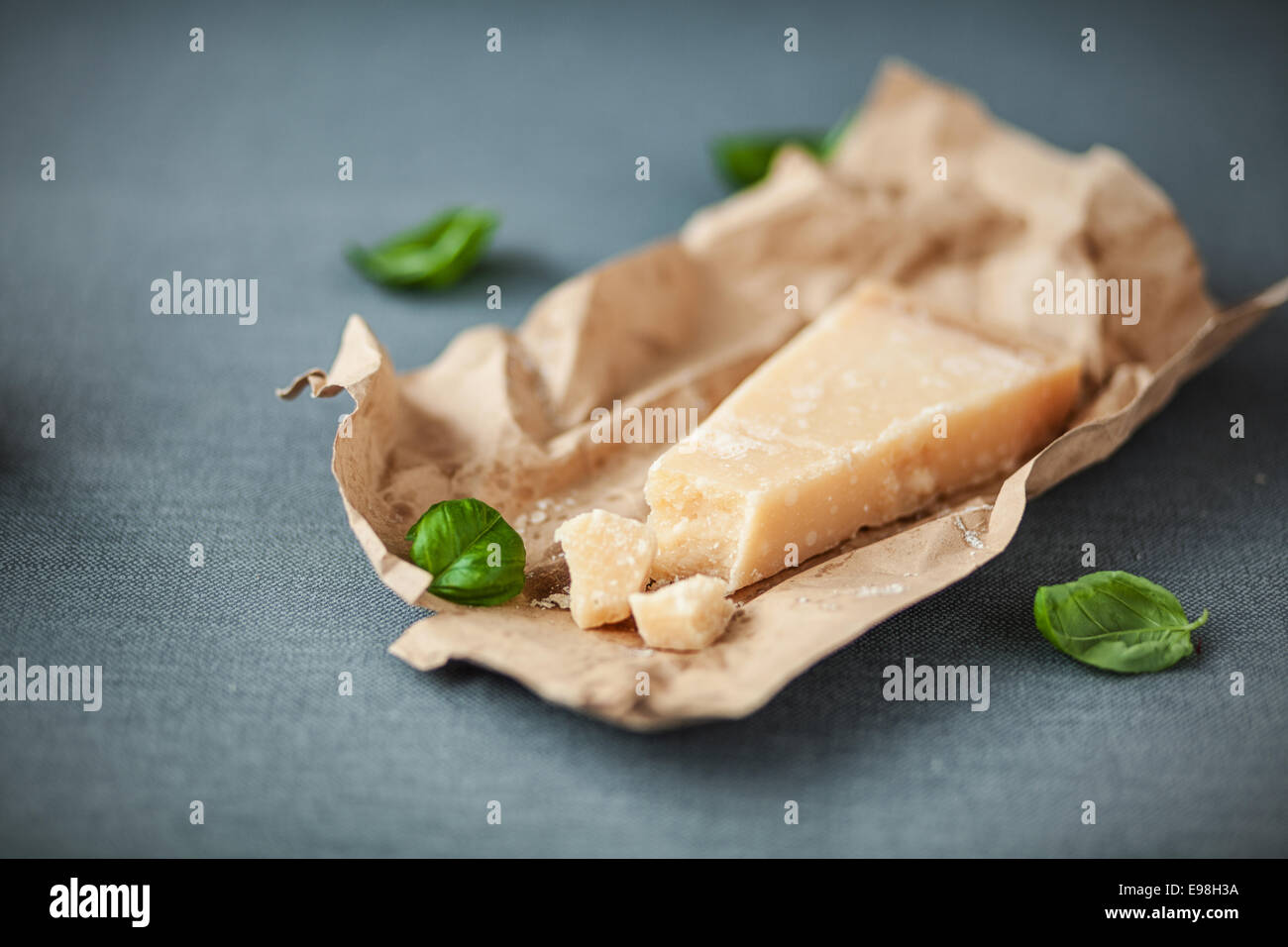 https://c8.alamy.com/comp/E98H3A/portion-of-mature-italian-parmesan-cheese-with-a-traditional-hard-E98H3A.jpg