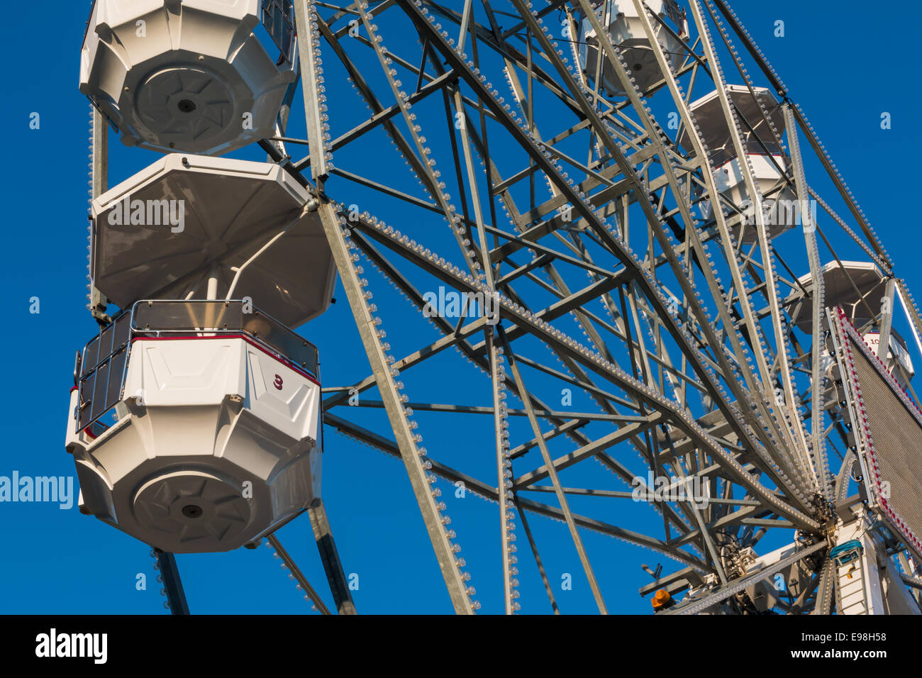close up white ferris wheel against blue sky Stock Photo - Alamy