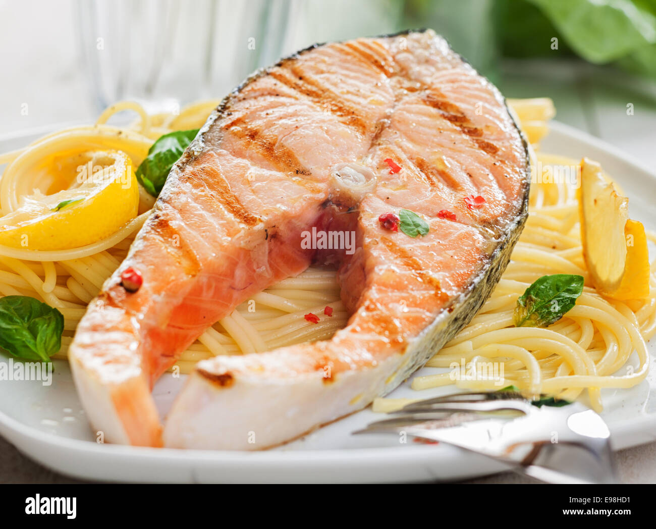 Gourmet grilled salmon steak or fillet on a bed of Italian linguine