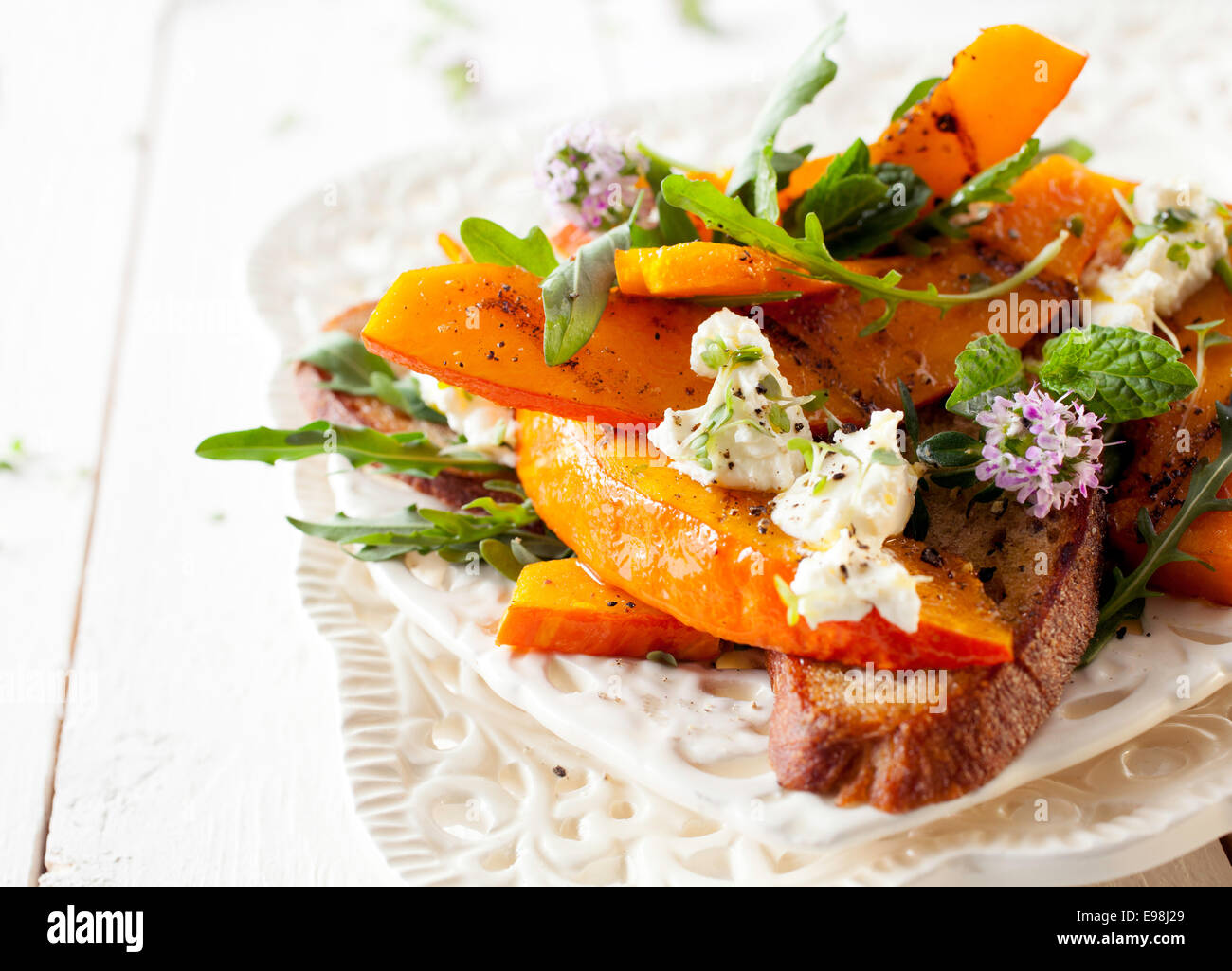 Macro Gourmet Hokkaido Pumpkin Salad Flowering Style on White Table. Stock Photo