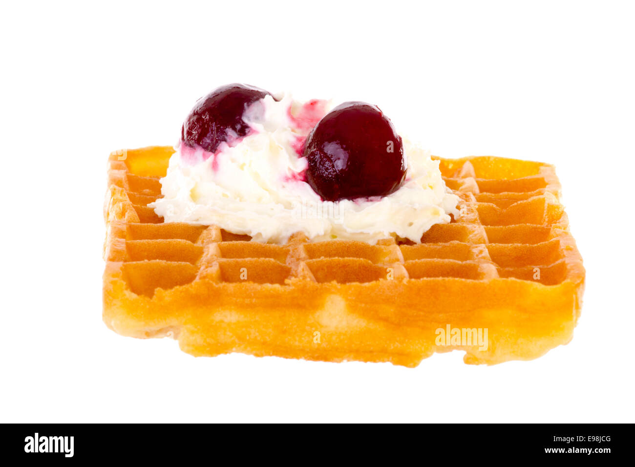 Cherries and whipped cream on freshly baked waffle brightened Stock ...
