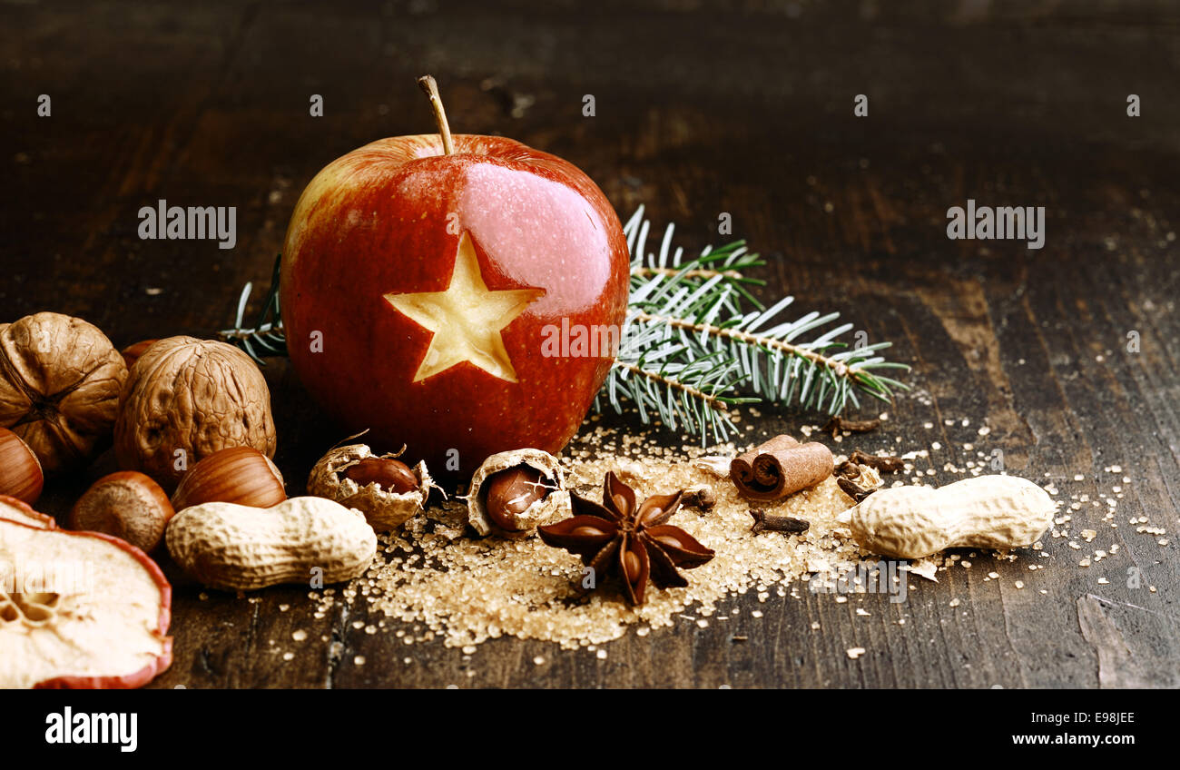 Sweet Red Holiday Apple with Nuts on Wooden Table. Stock Photo