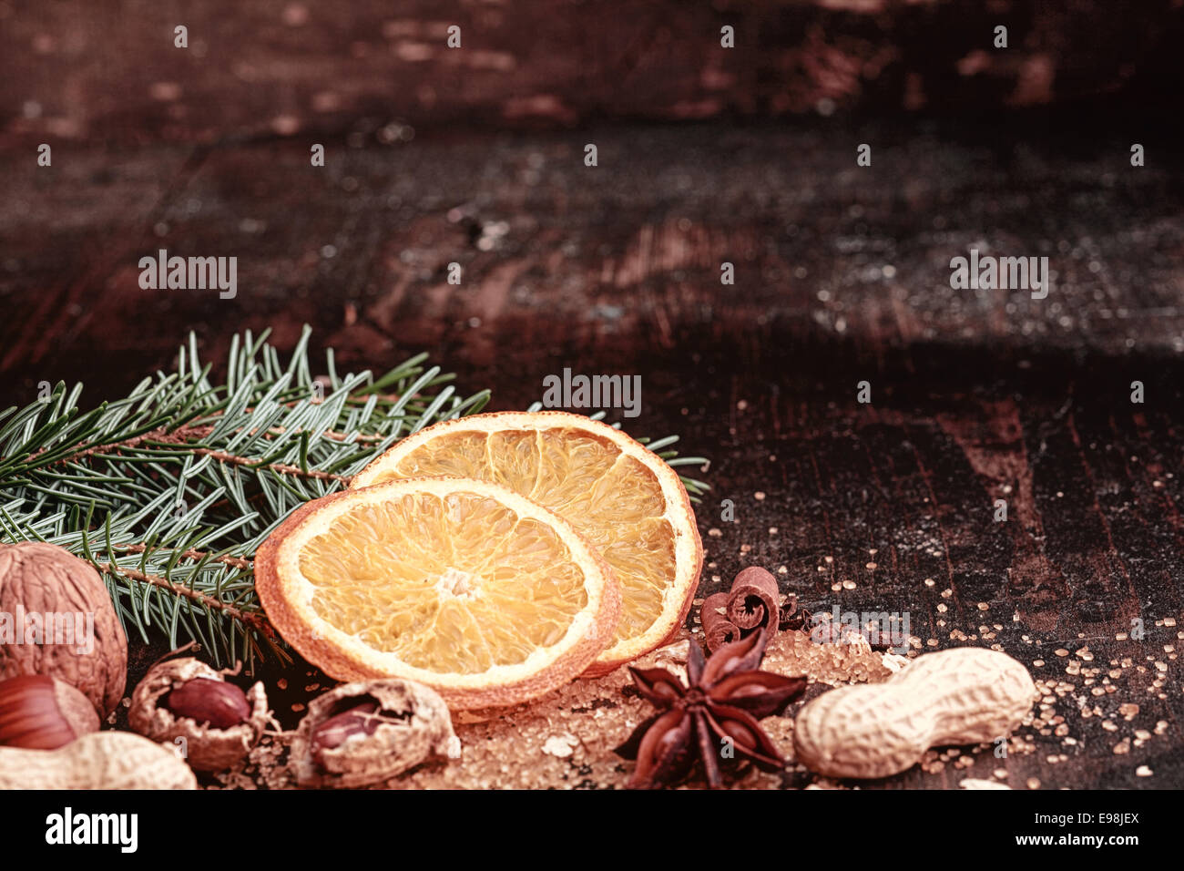 Sliced Christmas Orange, Nuts on Side, on Wooden Table Stock Photo