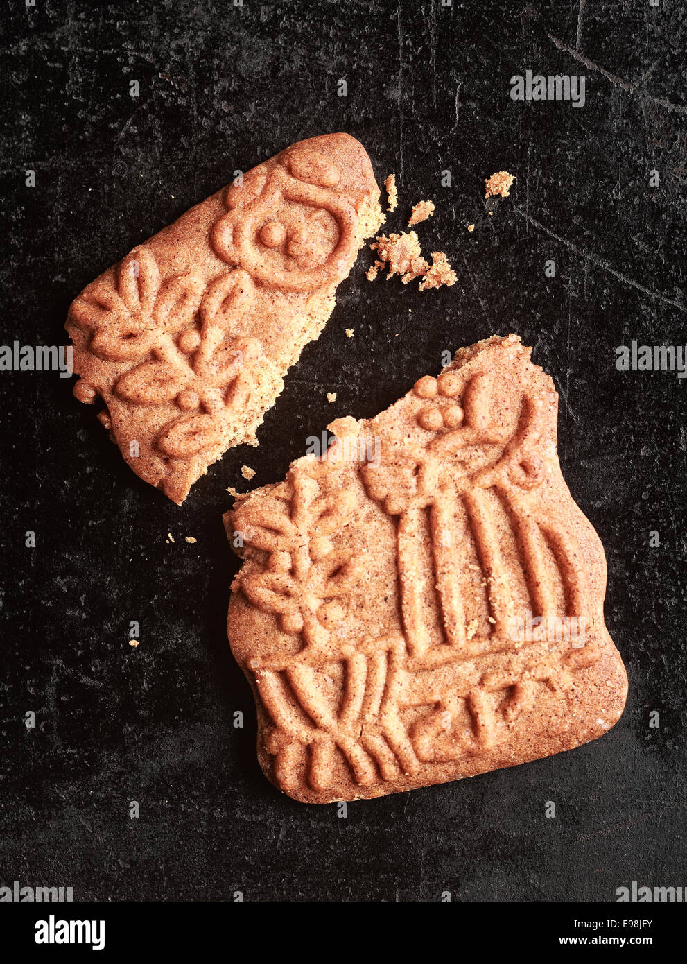 Traditional Dutch speculoos biscuit, a spicy crunchy shortcrust cookie for the feast of St Nicholas, now served to celebrate Christmas worldwide, broken and crumbled Stock Photo
