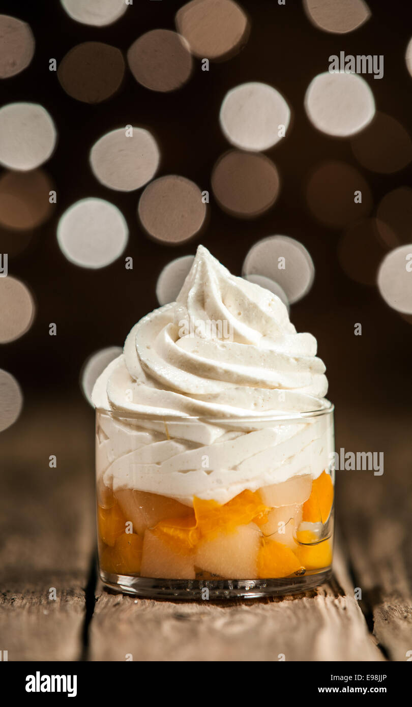 Macro Tasty Frozen Yogurt Above Mango Slices on Round Glass Container