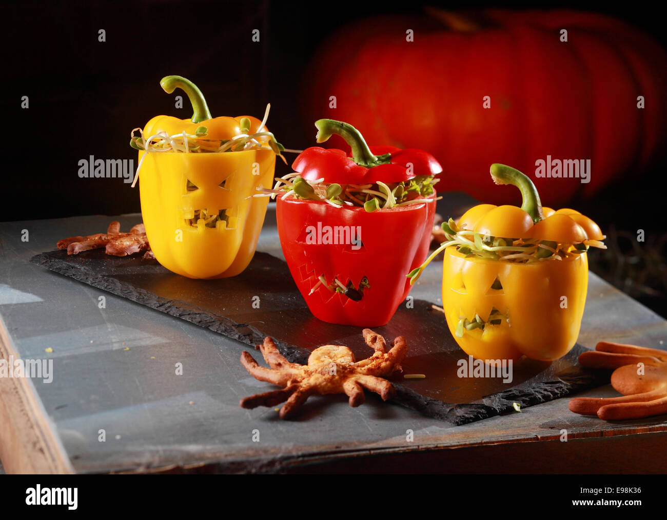 Red and Yellow Peppers with Scary Faces Stuffed with Sprouts with Edible Octopus Stock Photo