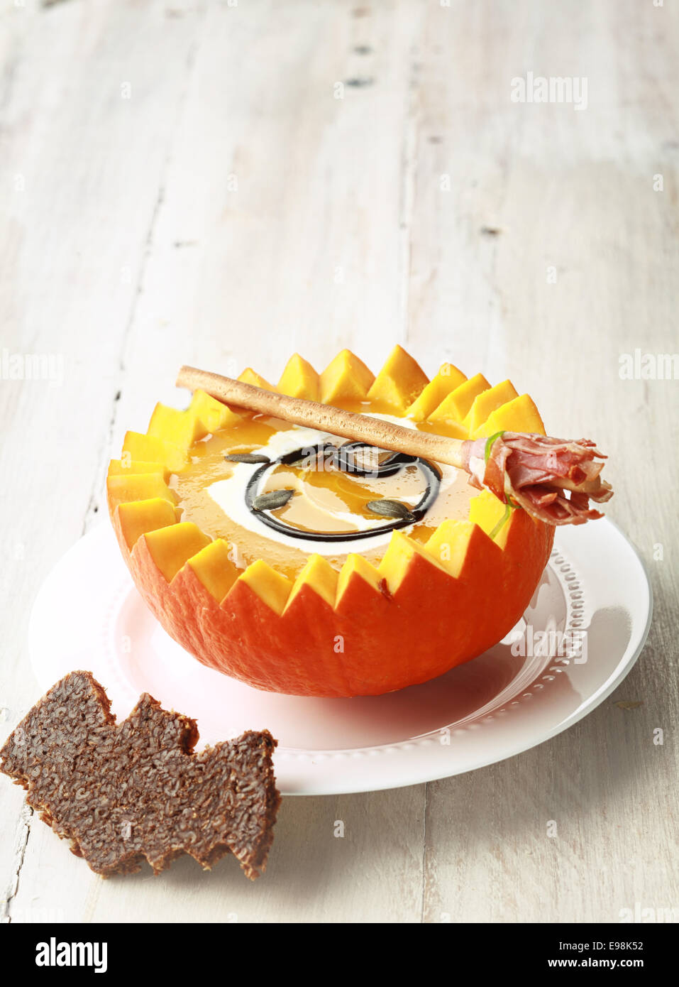 Pumpkin Soup with Bat Shaped Toast Crouton and Broomstick Bread Stick and Copyspace Stock Photo