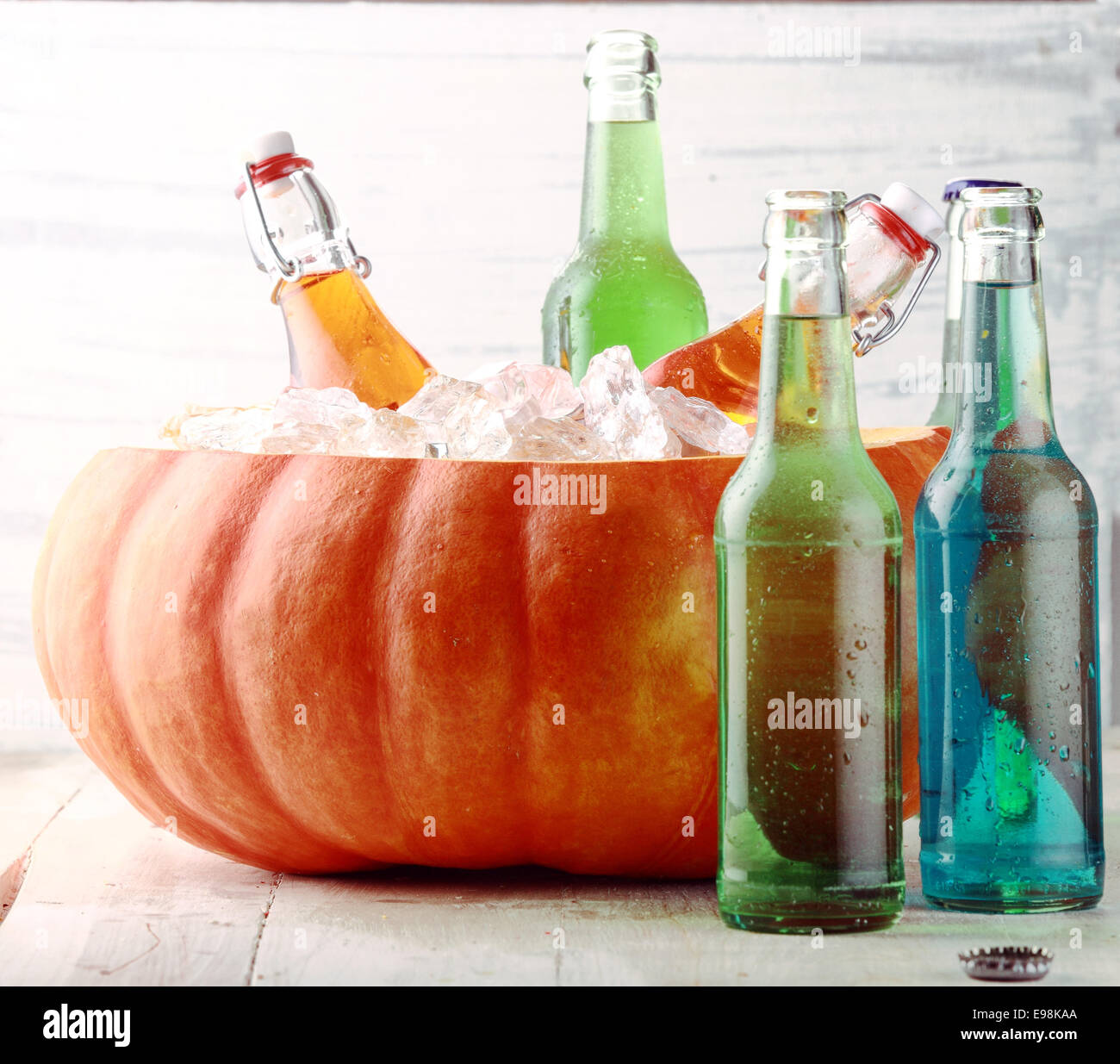 Bottled Beverages Chilling in Pumpkin Ice Bucket Stock Photo