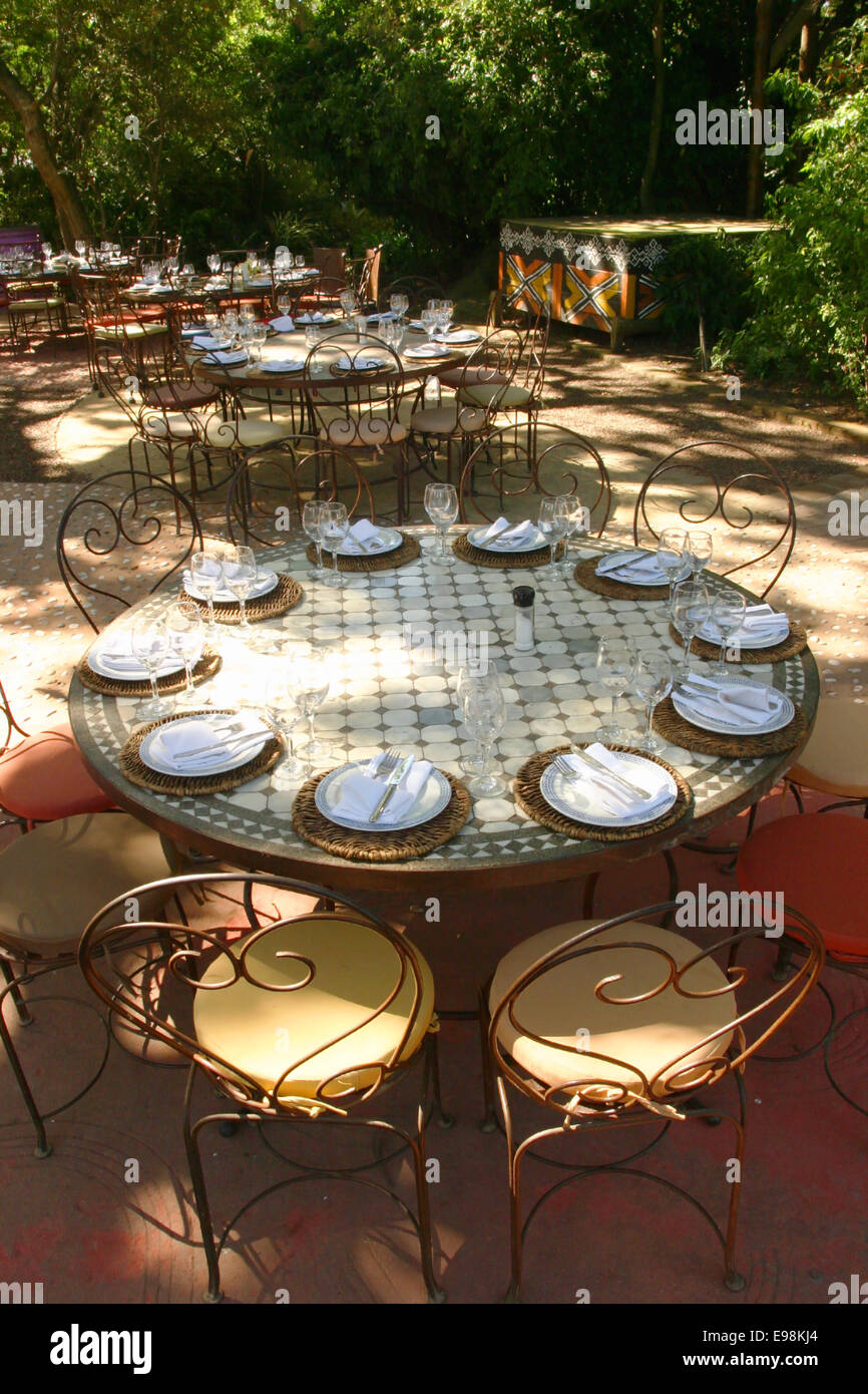 Banquet table in South afrika with african chairs under a big tree