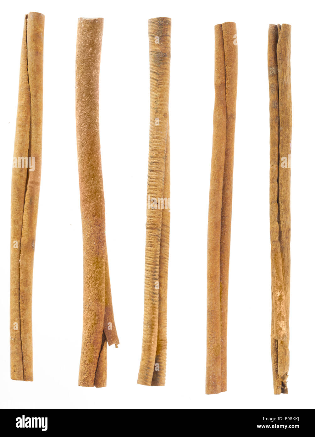 five cinnamon sticks isolated on white. High angled cinnamon sticks on