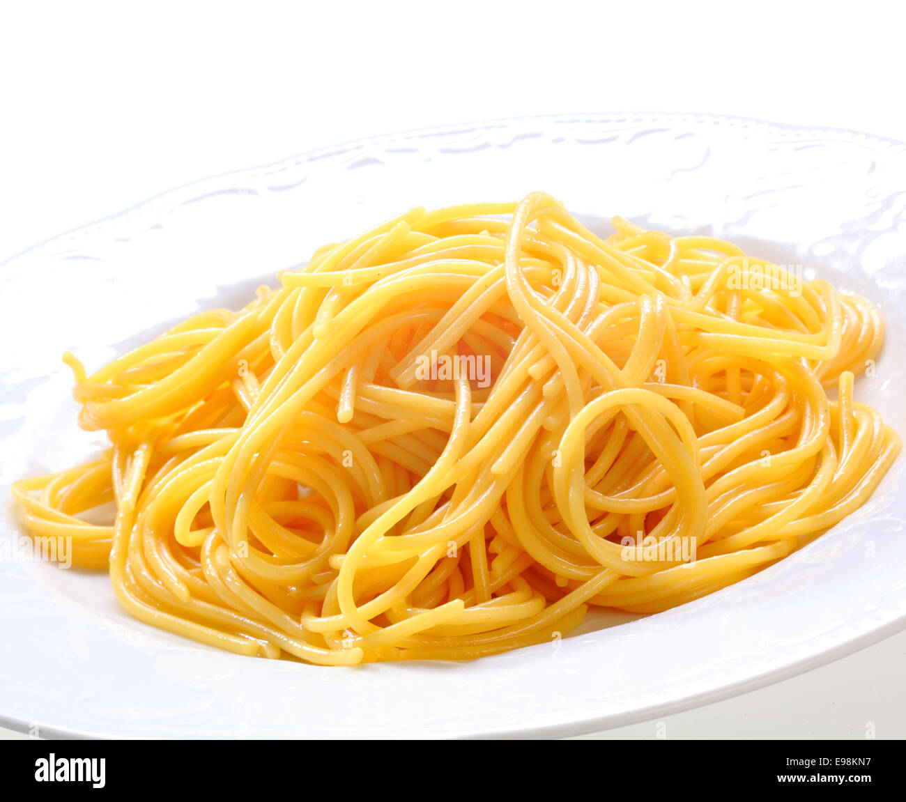 Plate Of Fresh Spaghetti. Freshly prepared spaghetti pasta without sauce on a white plate Stock