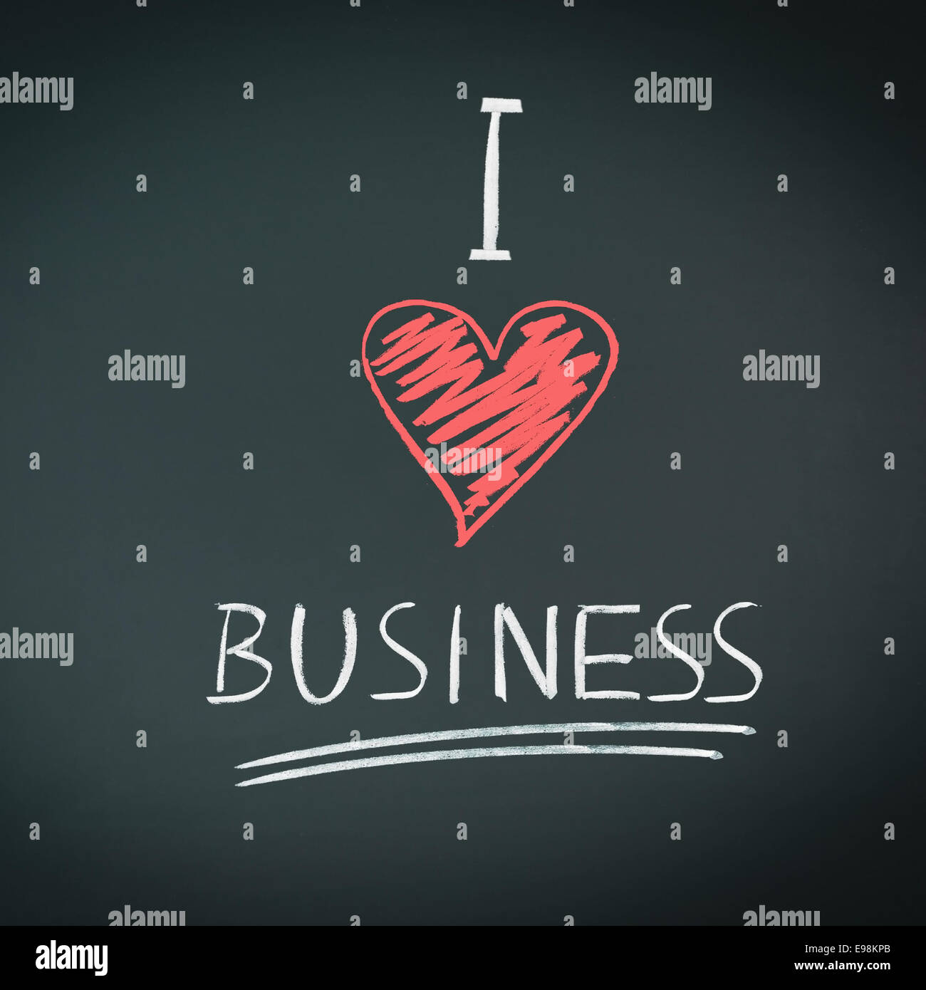 I Love Business. Handwritten message in chalk on a blackboard with a symbolic red heart for love. Stock Photo
