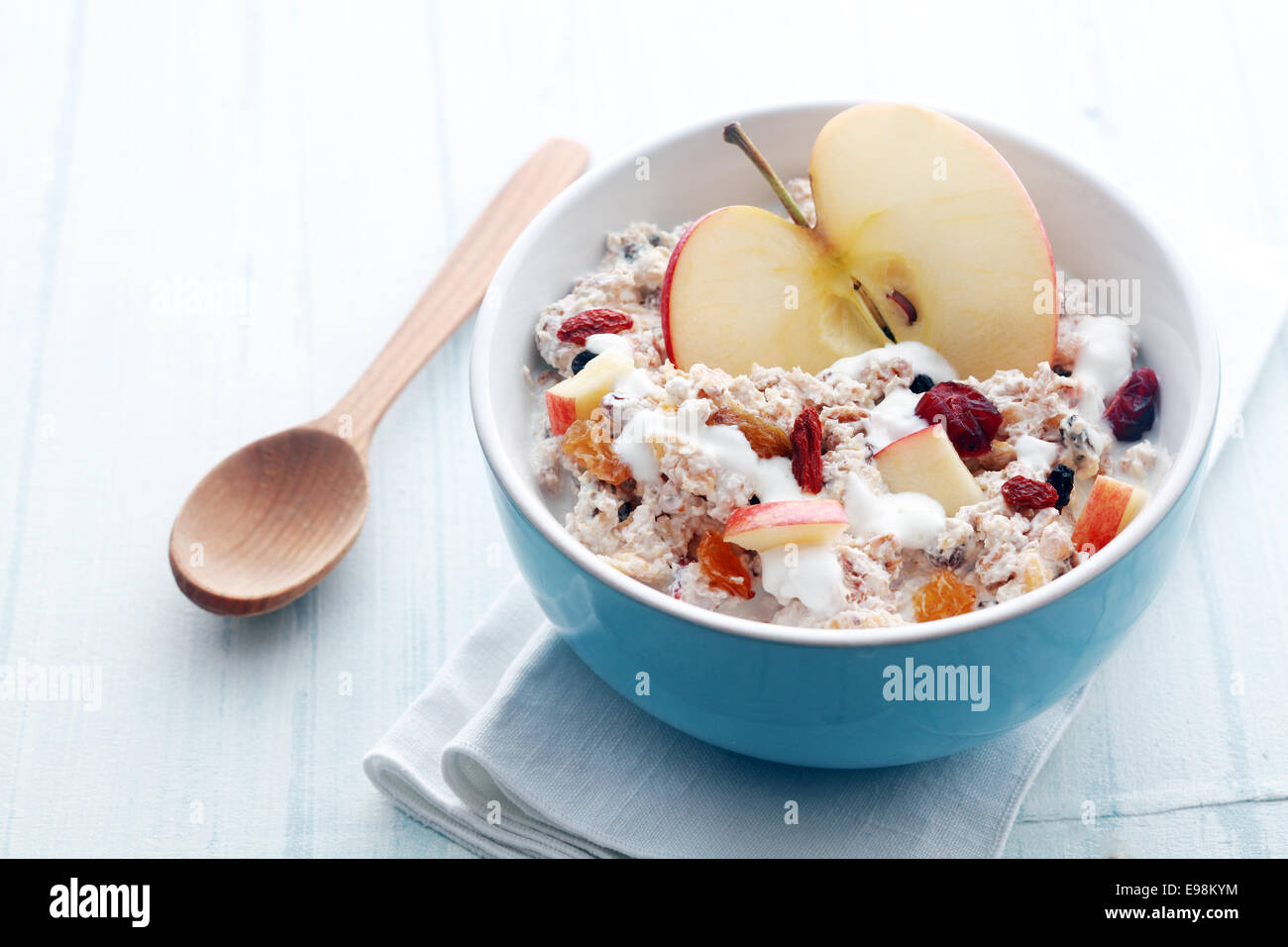 Healthy bowl of muesli, apple, fruit, nuts and milk for a nutritious breakfast with a low glycemic index ensuring plenty of energy for the day Stock Photo