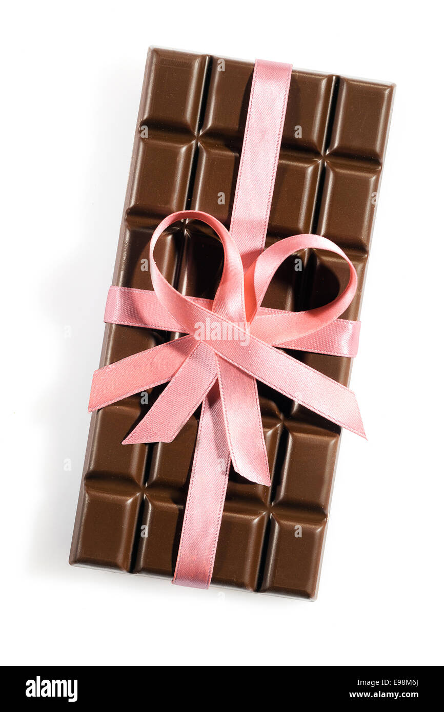 Chocolate bar with a rose or pink ribbon or bow isolated on white background Stock Photo