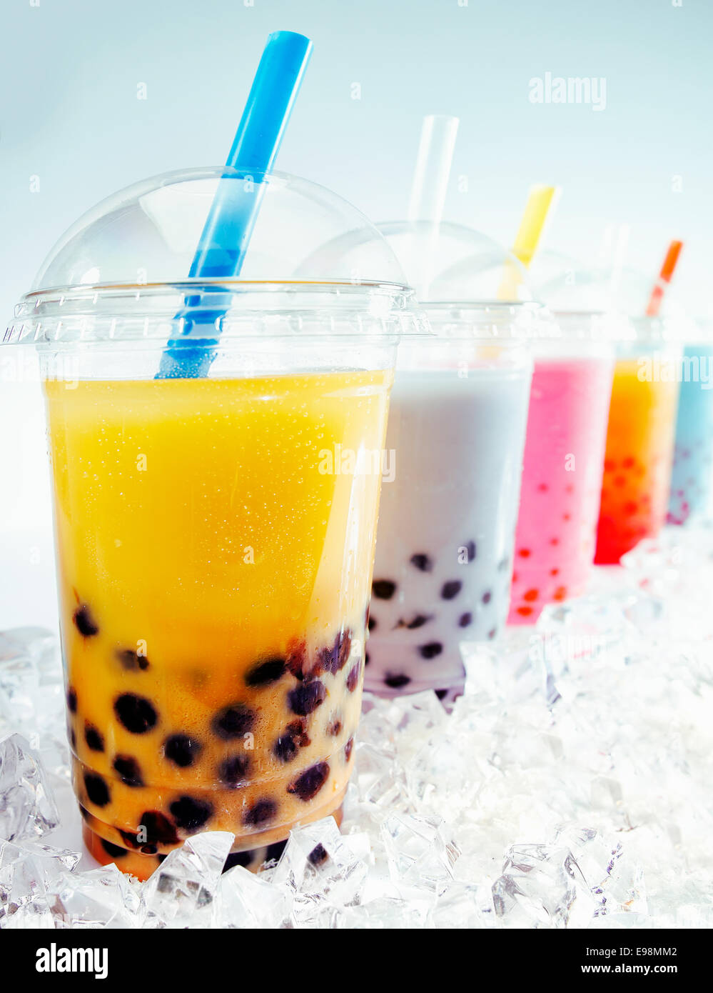 Assorted Fruity Boba Tea Cocktails in a row on crushed ice Stock Photo