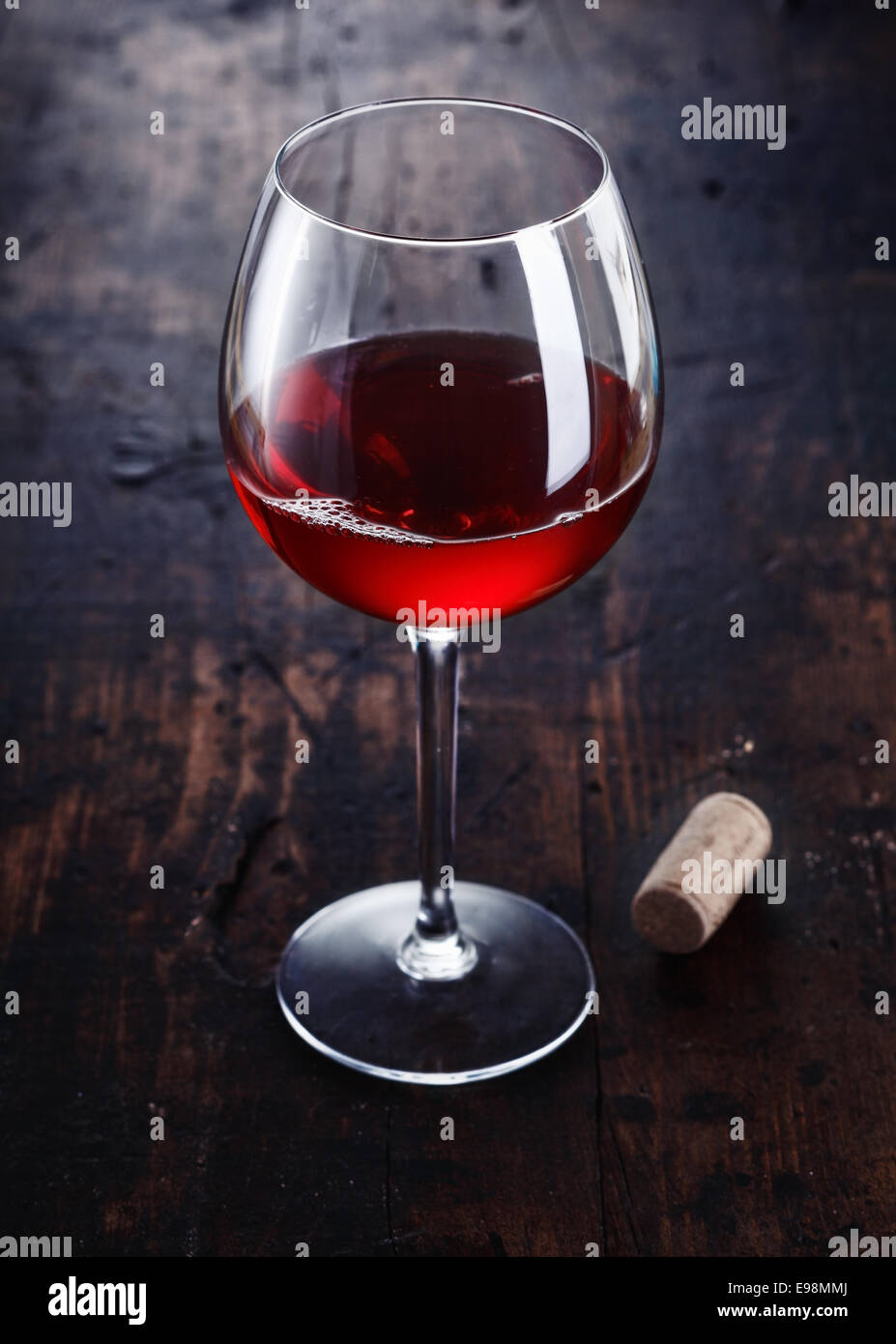 Dark red Merlot or Burgundy Wine with a cork on a wooden background Stock Photo