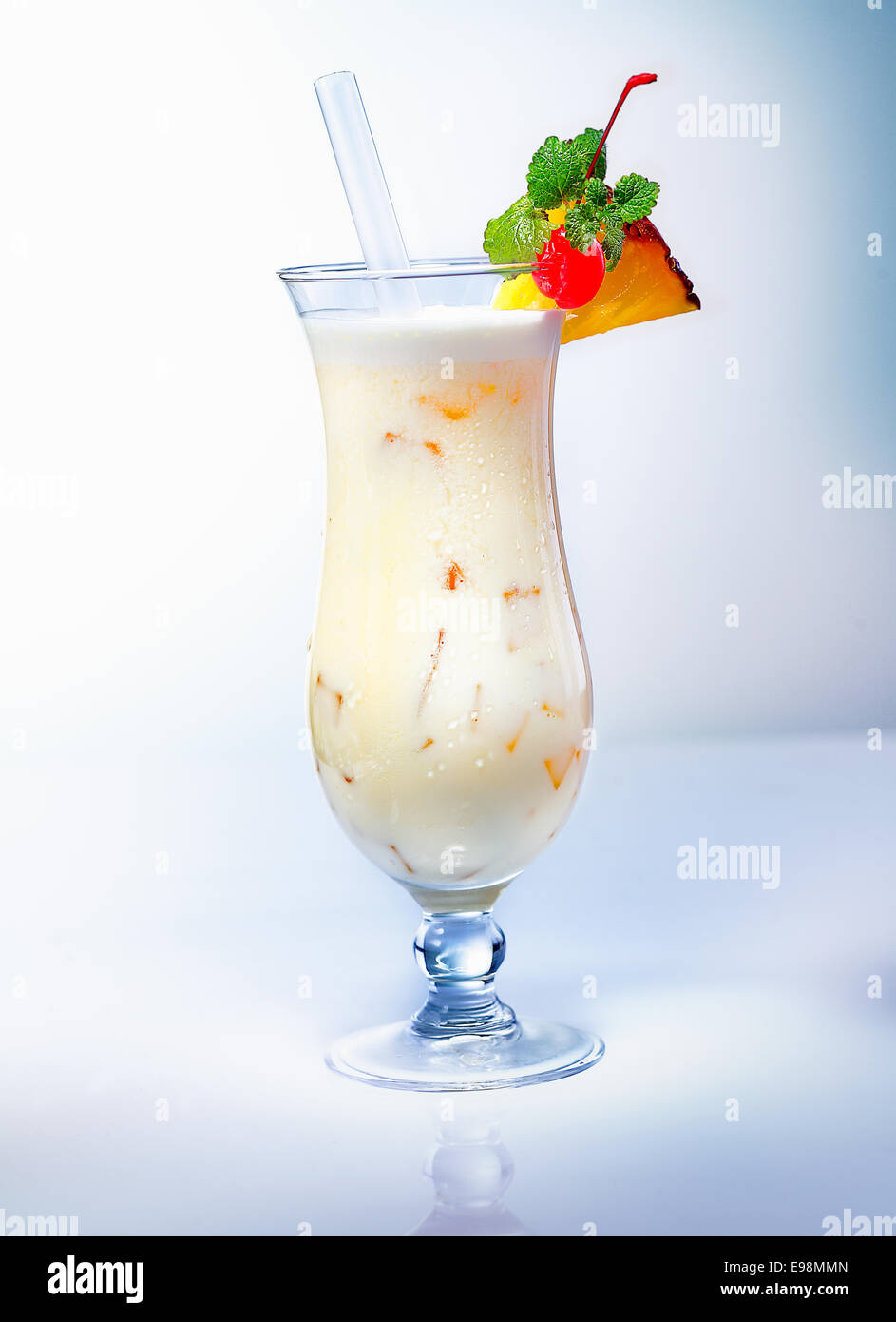 Pina Colada drink with a pineapple slice an a cocktail cherry. Many other cocktails in my portofolio. Stock Photo