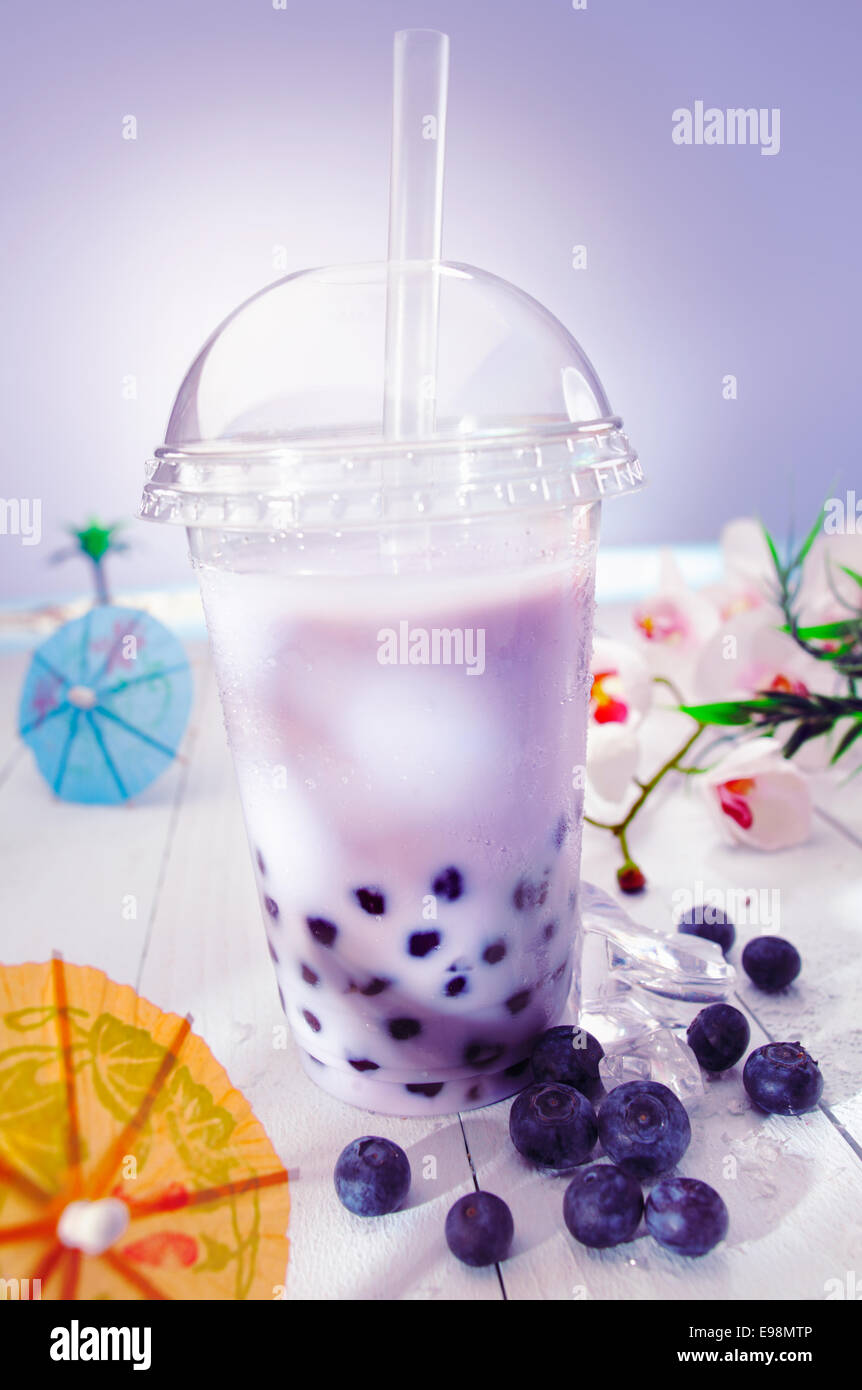 Bubble tea blended with milk and black currant berries and purple boba or pearls Stock Photo