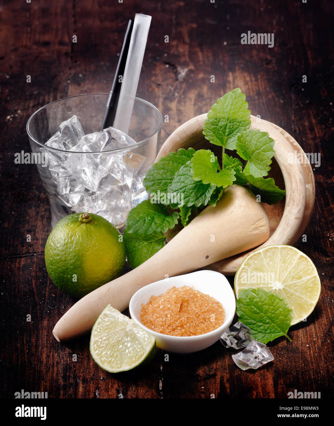 Ingredients for Mojito and Caipirinha. Mortar,Pestle and Lime. Brown sugar and an empty glass with straws Stock Photo