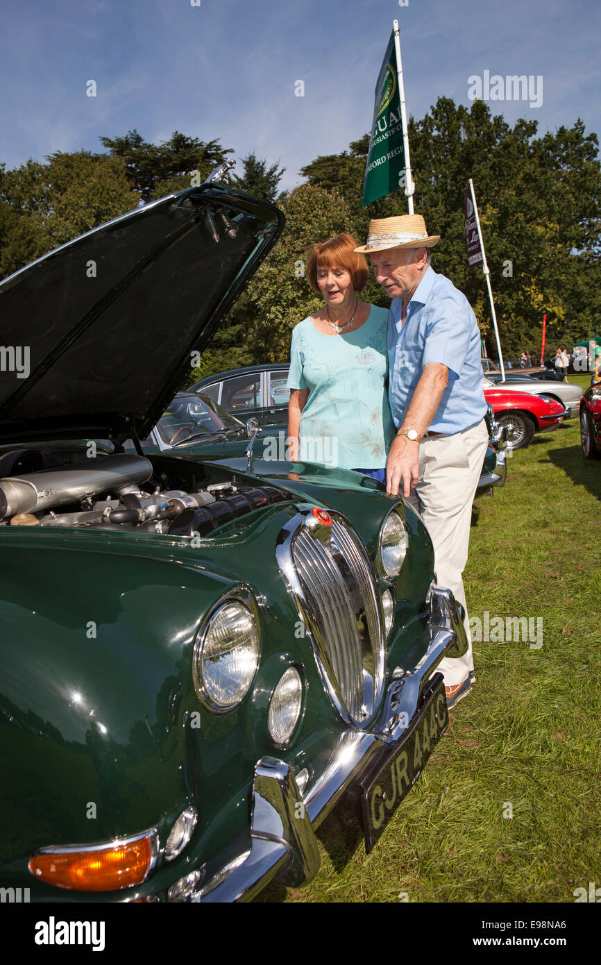 UK, England, Warwickshire, Warwick Castle, couple looking at engine of vintage 1965 Jaguar 3.4 litre S type car Stock Photo