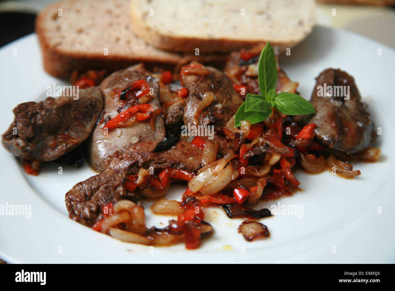 Pan fried chicken livers with caramelised onions and red peppers served