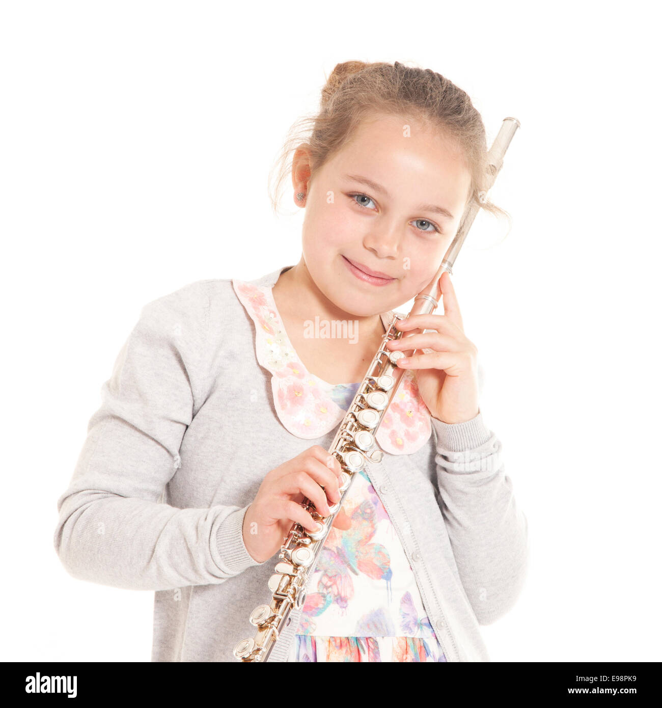 young girl holding flute against white background in studio Stock Photo