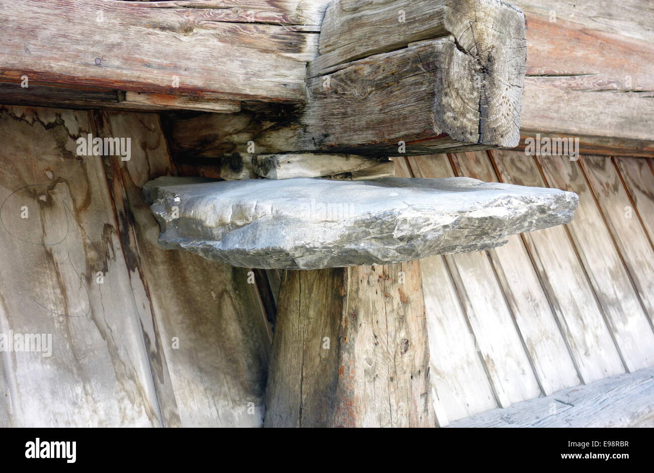 Rock supporting a wooden structure Stock Photo