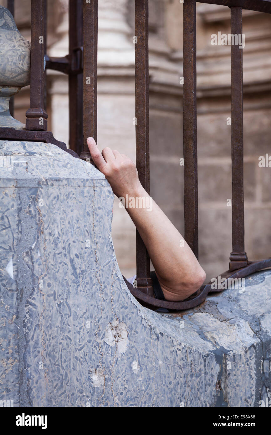 Arm On Railing Odd photo of an arm protruding through railings Stock Photo - Alamy
