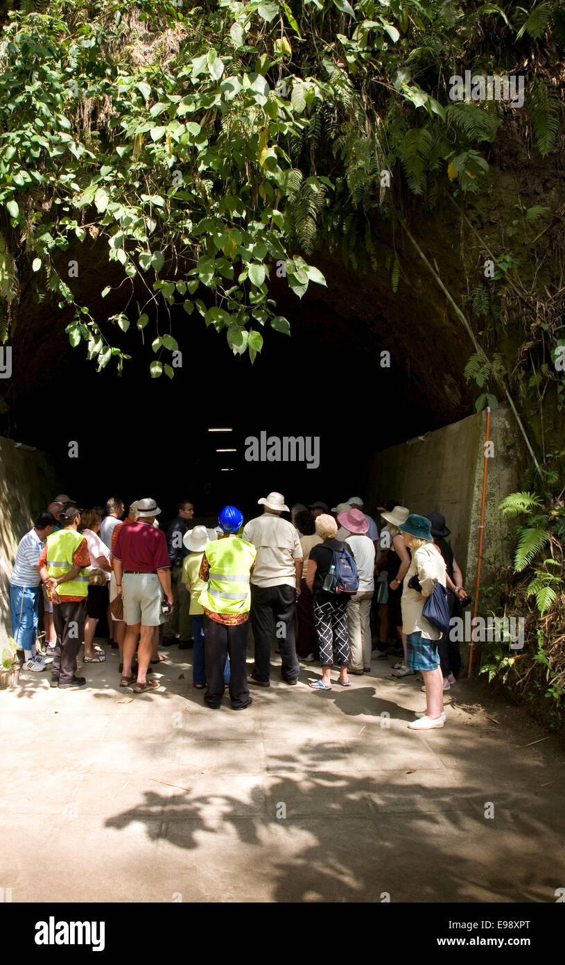 Tourists at a World War II Japanese barge tunnel housing the remains of transport barges, Rabual, New Britain Island, Papua NG Stock Photo
