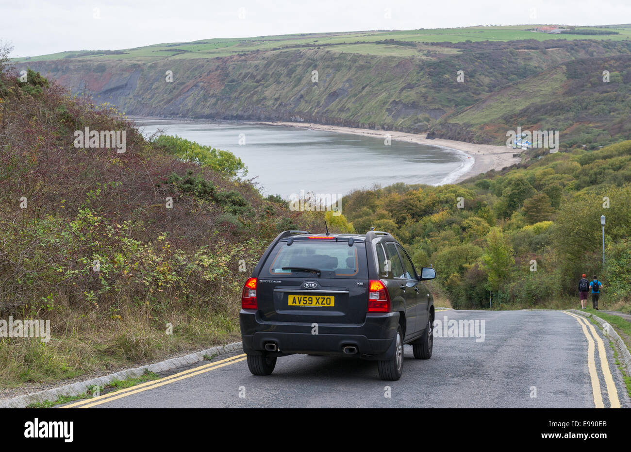 Motor vehicle descending the hill to Runswick bay on the north Yorkshire coast. Stock Photo