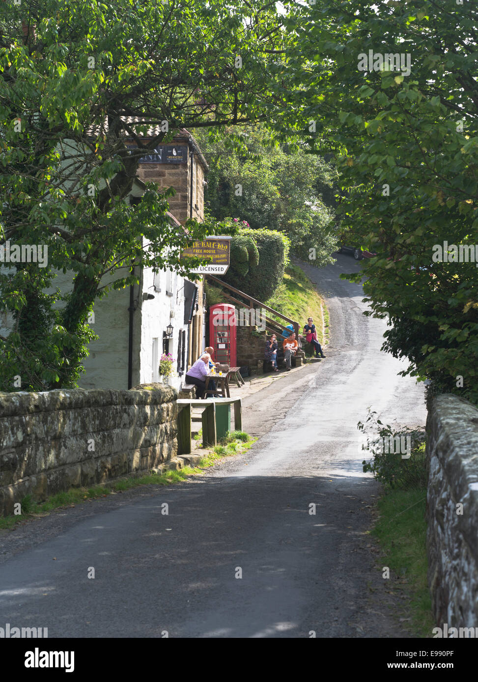 dh Birch Hall Inn North York Moor BECK HOLE PUB NORTH YORKSHIRE UK British People outside public house drinking beer country in summer uk summertime Stock Photo