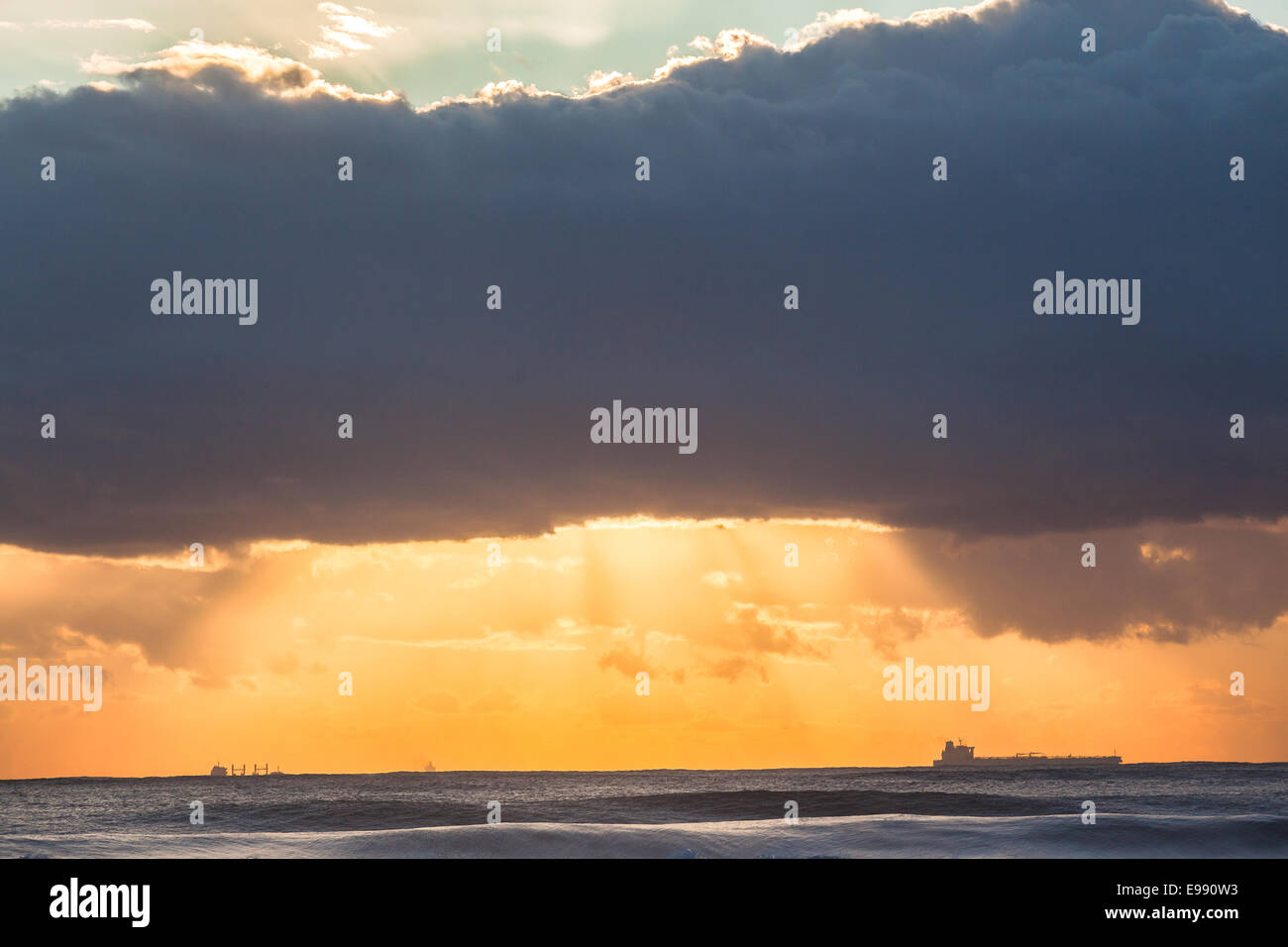 Ships dawn sunrise silhouetted on ocean sea horizon landscape Stock ...