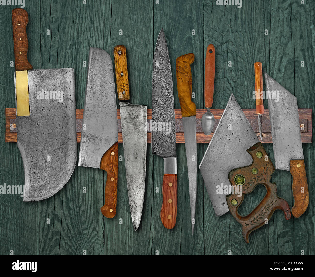 vintage set of knives on the magnet rack against wall Stock Photo