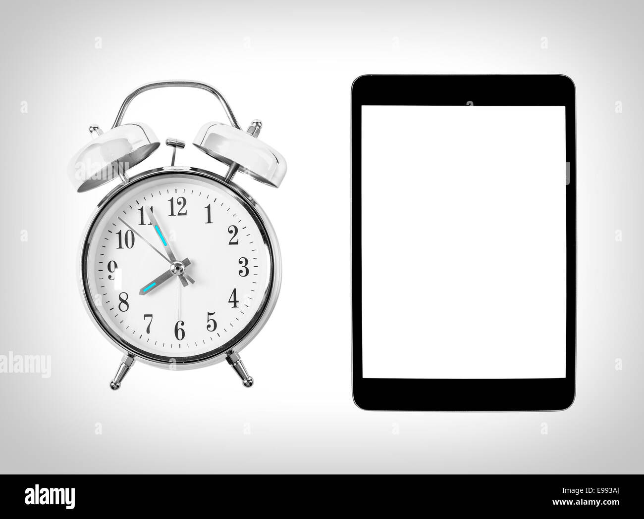 Tablet computer and alarm clock. Time and technology. Concept Stock