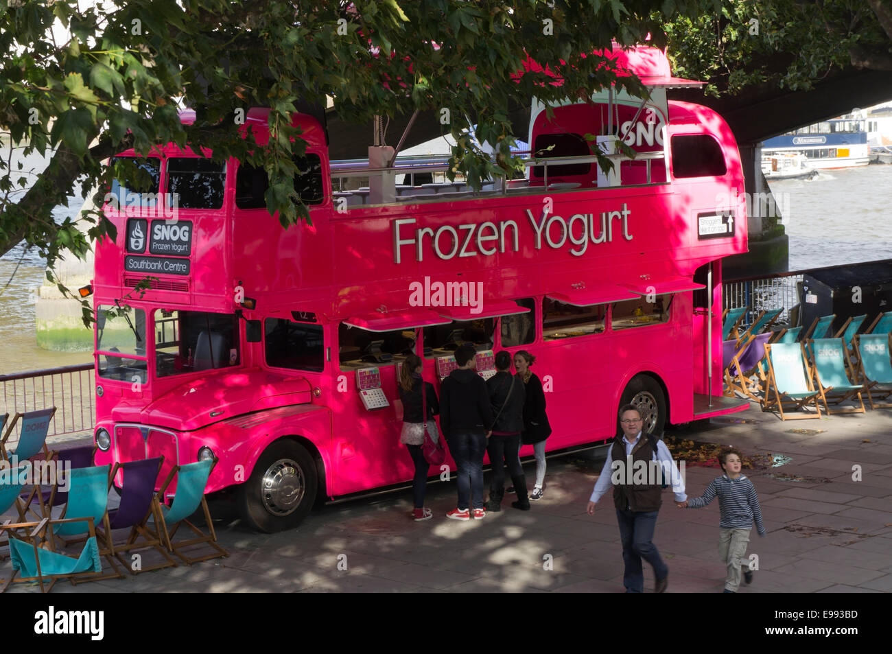 A pink double-decker bus selling Snog frozen yogurt on the Southbank in London. Stock Photo