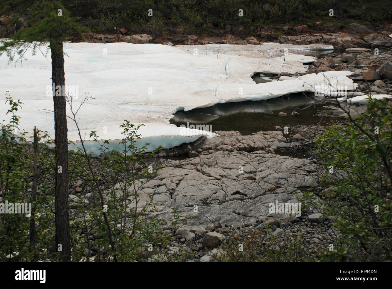 Timan Ridge The ice-field in the tideway of the mountain river. The Putorana ...