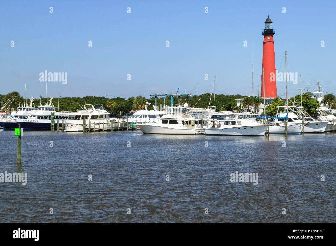 Historic Ponce de Leon Inlet Lighthouse with Lighthouse Boatyard and Marina seen from the Atlantic Intracoastal Waterway Stock Photo