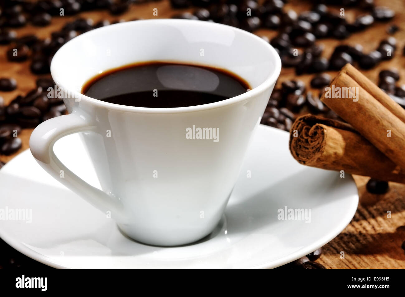 a hot cup of black coffee with coffee beans Stock Photo