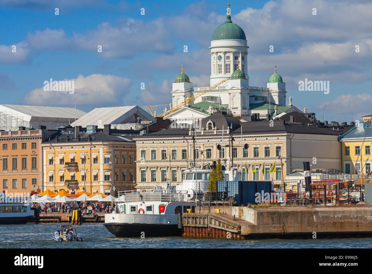 HELSINKI, FINLAND - SEPTEMBER 13, 2014: central quay of Helsinki with moored ships, walking people and dome of the main city cat Stock Photo