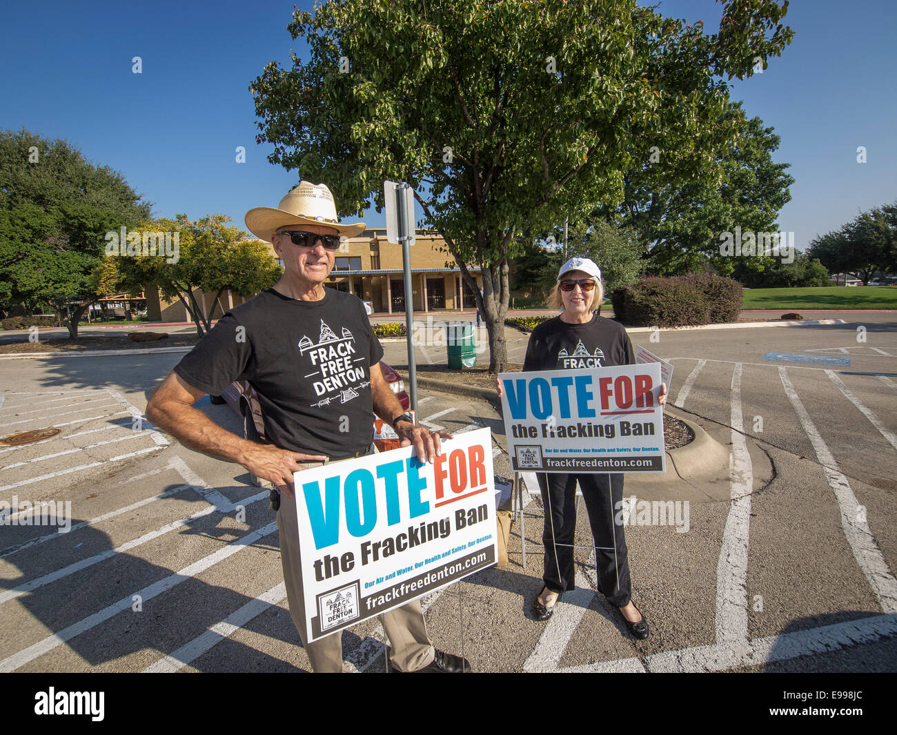 Texas, USA. 22nd Oct, 2014. Denton Texas residents Michael Hennen and Susan Vaughan campaign for banning in November elections hydraulic fracturing when drilling, used in drilling for oil and natural gas. For a 'Frack Free Denton,' stated on their t-shirt. Credit:  J. G. Domke/Alamy Live News Stock Photo