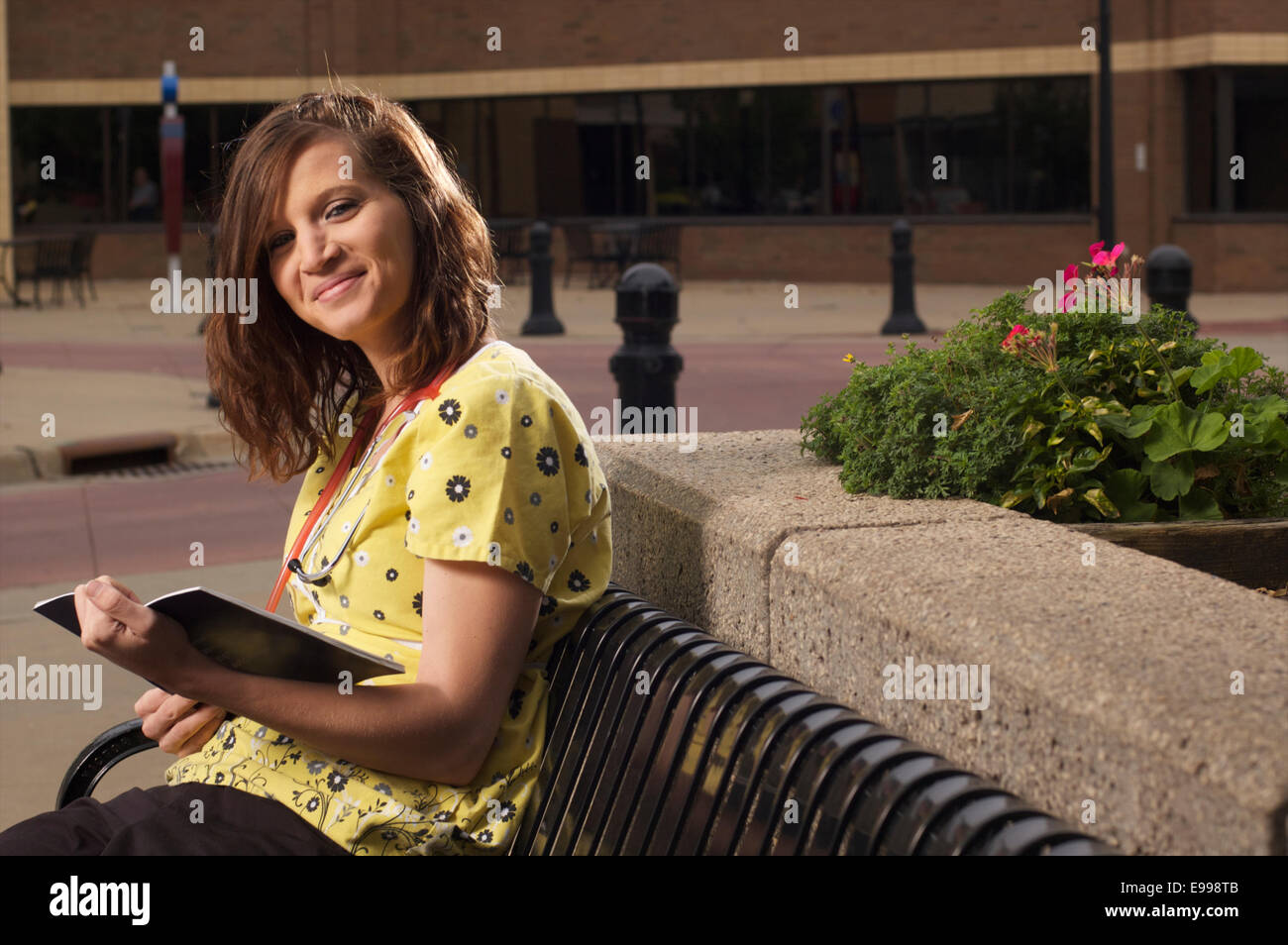 a young nurse women sitting reading during her lunch break Stock Photo