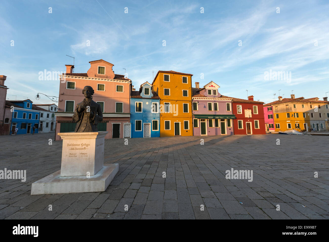 Piazza Baldassare Galuppi with statue dedicated to him in Burano  known for its brightly coloured homes near Venice. Stock Photo